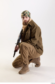 Andrew Elliott Insurgent Kneeling with Machine Gun holding machine gun…